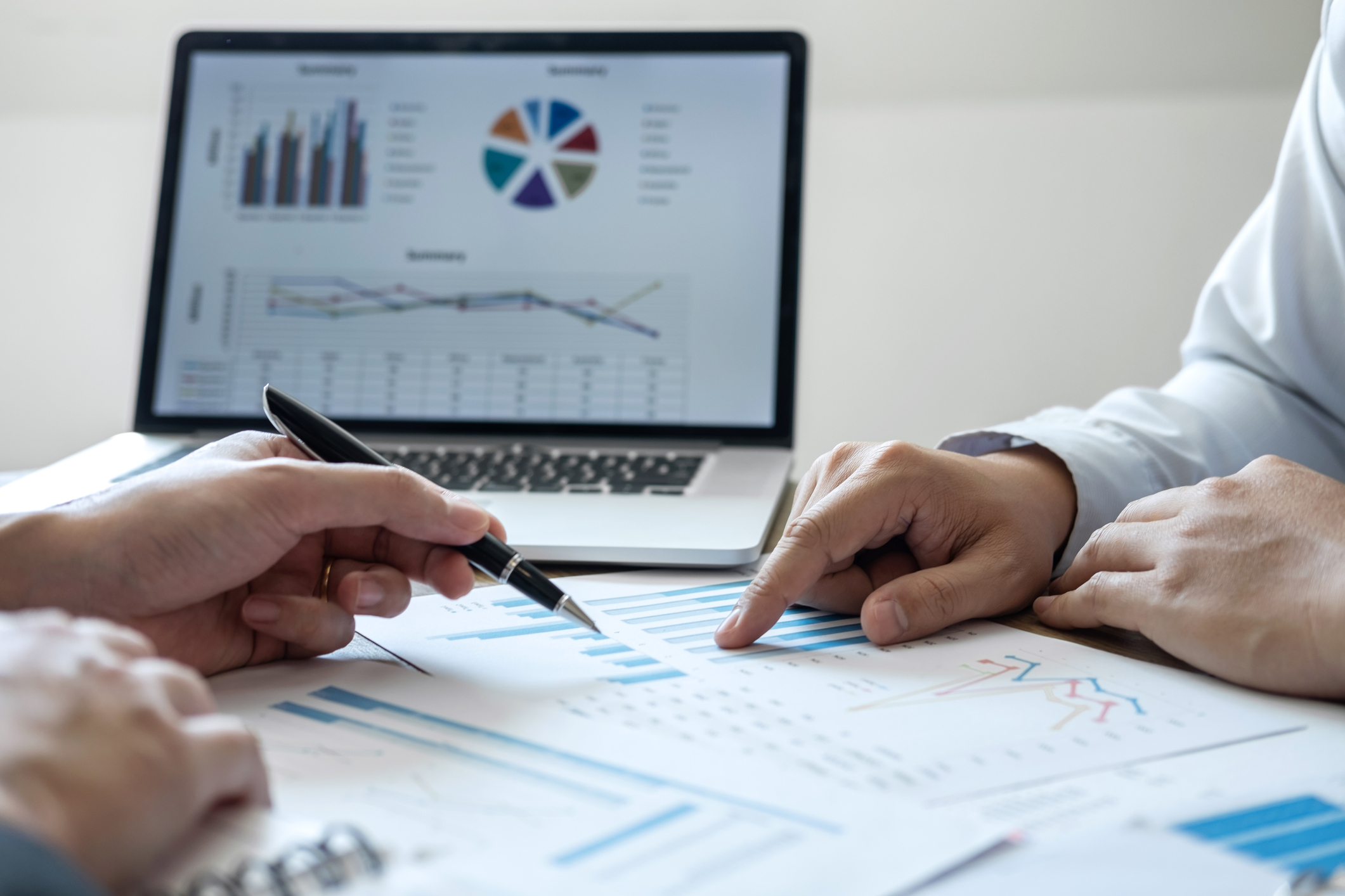 Cropped Hands Of Colleagues Discussing Data On Desk In Office